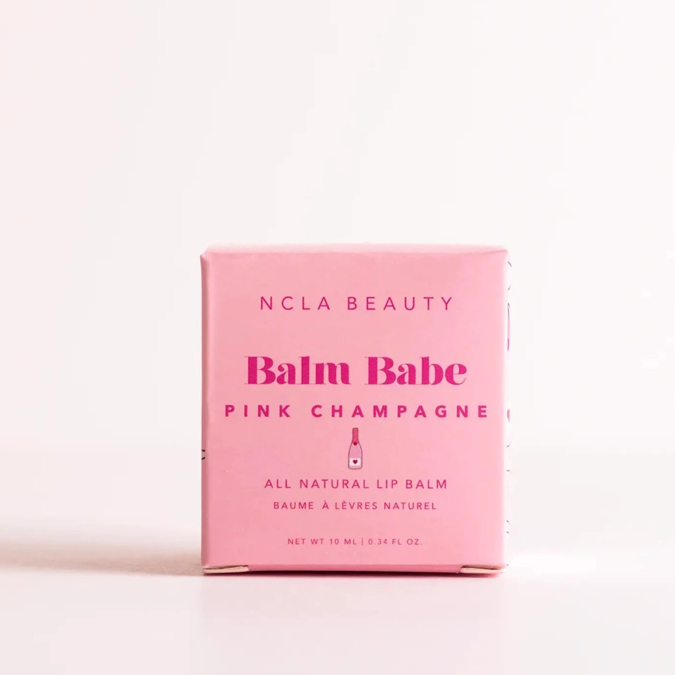 packaging for the balm babe pink champagne all natural lip balm. pink cube box with pink text
