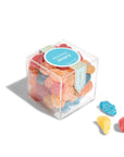 clear acrylic cube containing the colorful star and moon shaped candy
