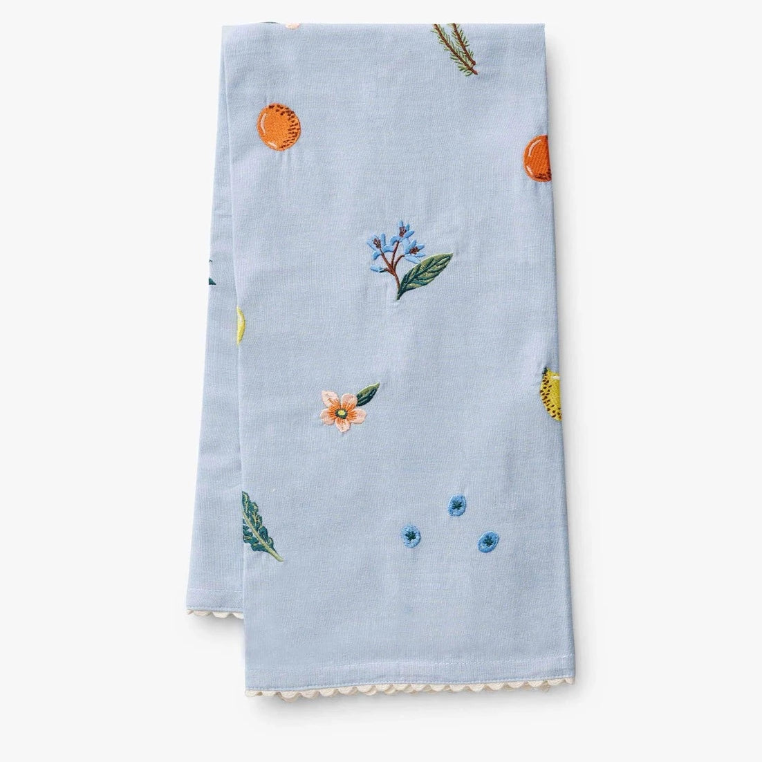 Folded blue towel with embroidered fruits and florals